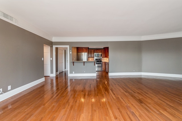 unfurnished living room with crown molding and dark hardwood / wood-style floors