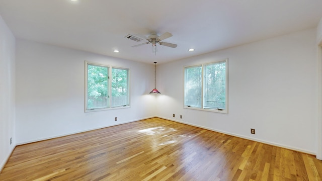 spare room featuring light hardwood / wood-style flooring and ceiling fan