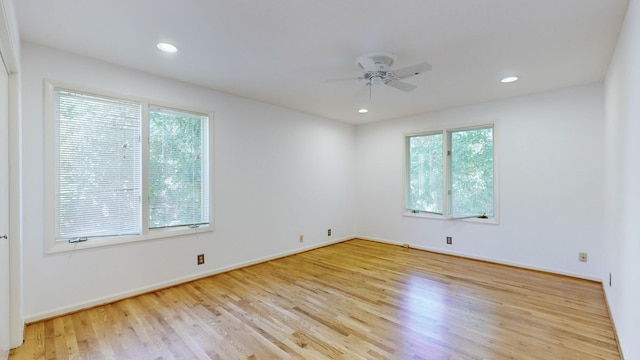 spare room with light hardwood / wood-style flooring and ceiling fan