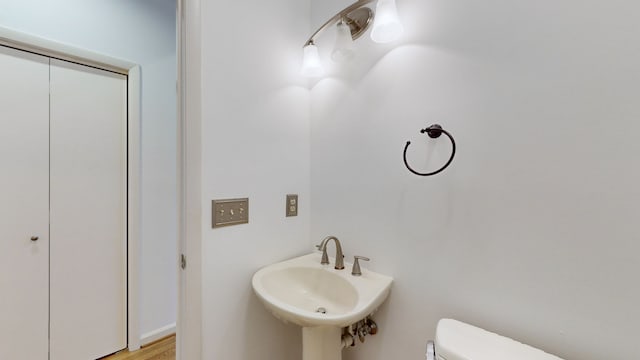 bathroom featuring sink, hardwood / wood-style flooring, and toilet