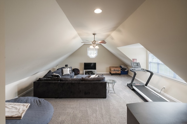 workout room featuring light carpet, ceiling fan, and vaulted ceiling