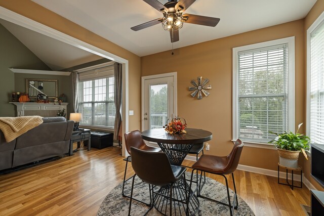 dining area with ceiling fan, light hardwood / wood-style floors, and lofted ceiling