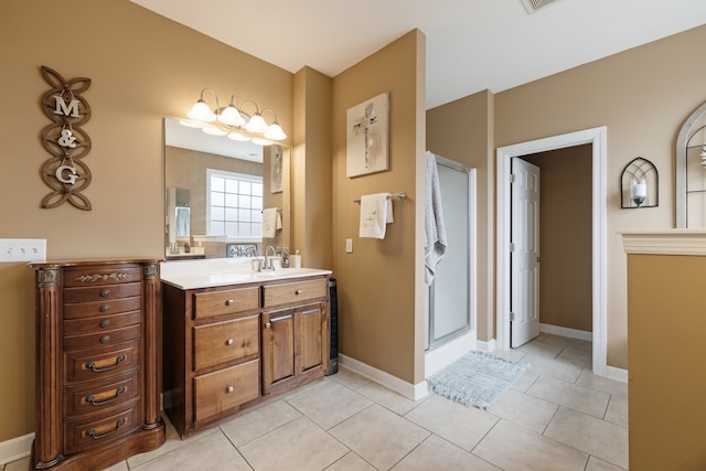 bathroom with tile patterned floors, vanity, and an enclosed shower