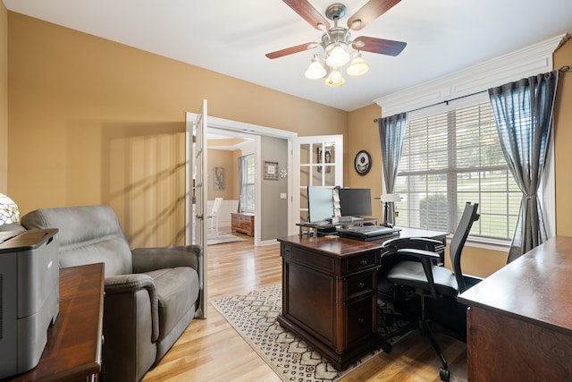 office featuring plenty of natural light, ceiling fan, light wood-type flooring, and french doors