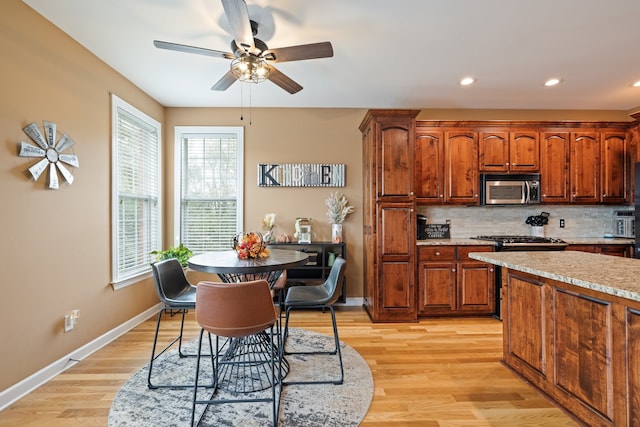 kitchen featuring tasteful backsplash, light hardwood / wood-style flooring, a wealth of natural light, and ceiling fan