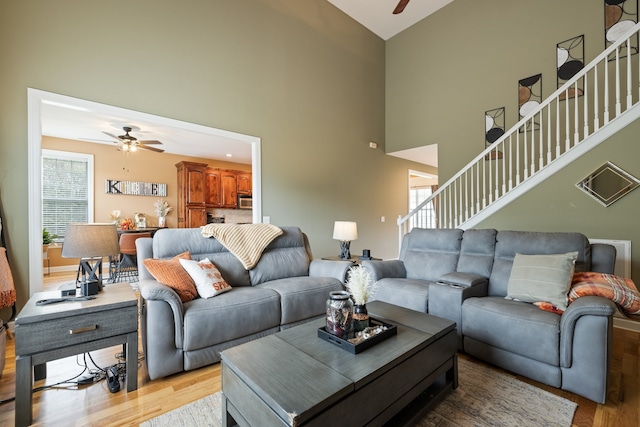 living room with ceiling fan, light hardwood / wood-style flooring, and plenty of natural light