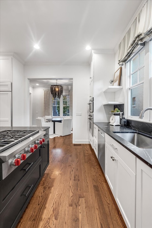 kitchen with white cabinets, appliances with stainless steel finishes, plenty of natural light, and sink