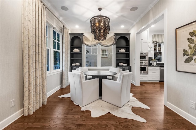 dining room featuring ornamental molding, built in features, dark wood-type flooring, and a notable chandelier