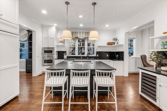 kitchen featuring a breakfast bar, a kitchen island, and dark hardwood / wood-style floors