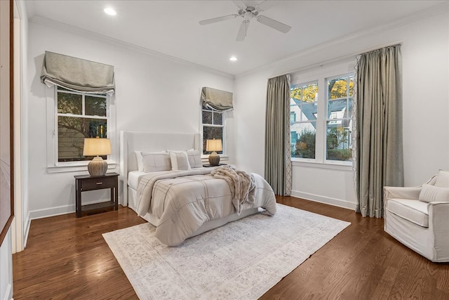 bedroom featuring ceiling fan, dark hardwood / wood-style flooring, and crown molding