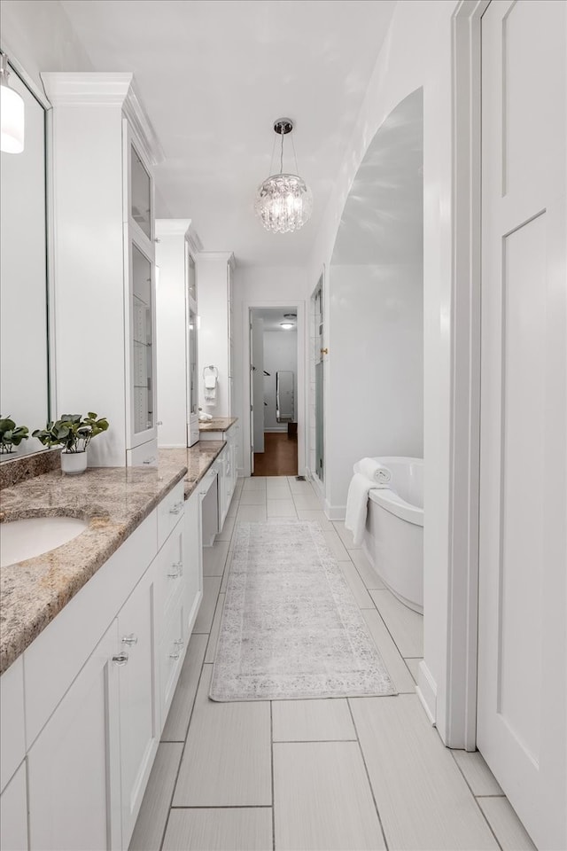 bathroom with tile patterned flooring, vanity, a chandelier, and shower with separate bathtub