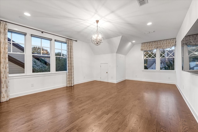 bonus room with dark hardwood / wood-style flooring, a chandelier, and vaulted ceiling