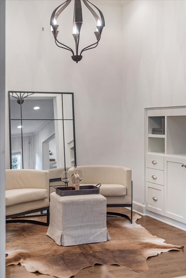 living area with hardwood / wood-style flooring and a notable chandelier