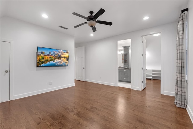 interior space featuring ensuite bathroom, ceiling fan, and dark hardwood / wood-style flooring