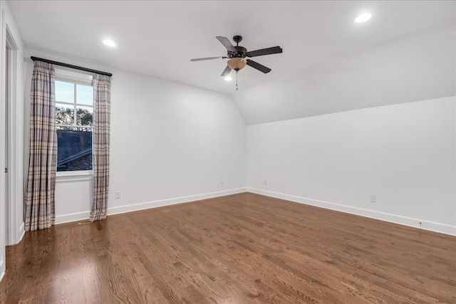 interior space featuring ceiling fan, dark wood-type flooring, and lofted ceiling