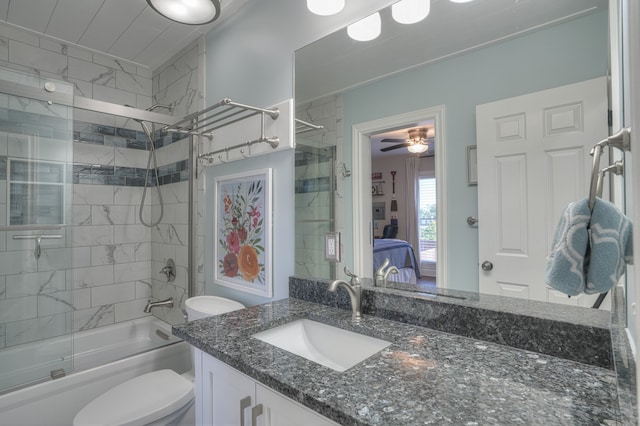 full bathroom featuring ceiling fan, vanity, toilet, and tiled shower / bath