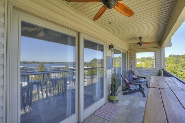 exterior space featuring a water view and ceiling fan