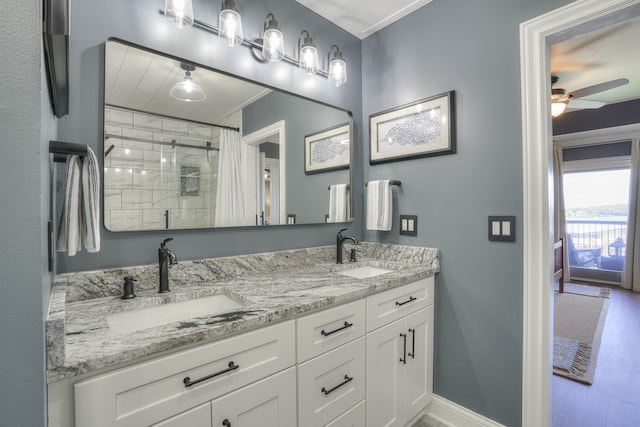 bathroom featuring ceiling fan, vanity, ornamental molding, wood-type flooring, and a shower with shower curtain