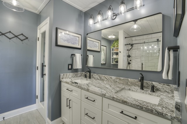 bathroom featuring crown molding, hardwood / wood-style floors, a shower with shower door, and vanity