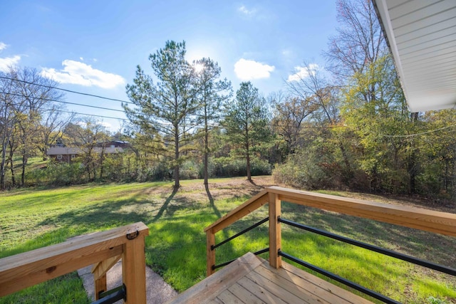 wooden terrace featuring a lawn