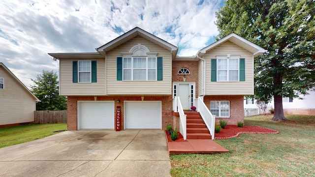 split foyer home featuring a garage and a front lawn