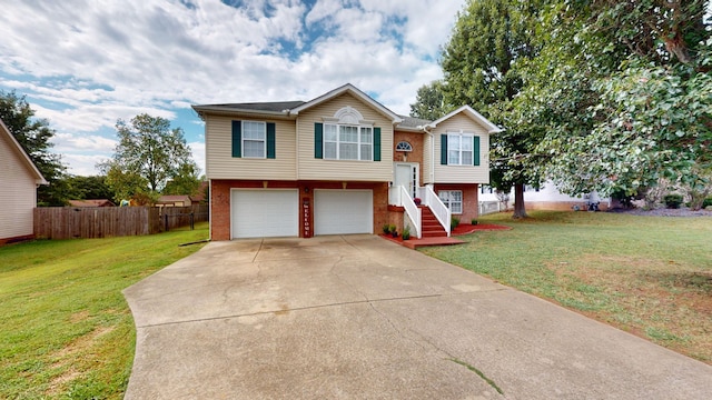 bi-level home featuring a garage and a front lawn