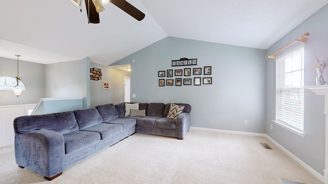 carpeted living room featuring ceiling fan and vaulted ceiling