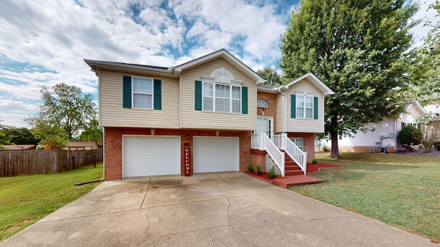 split foyer home with a garage and a front yard