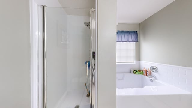 bathroom with separate shower and tub