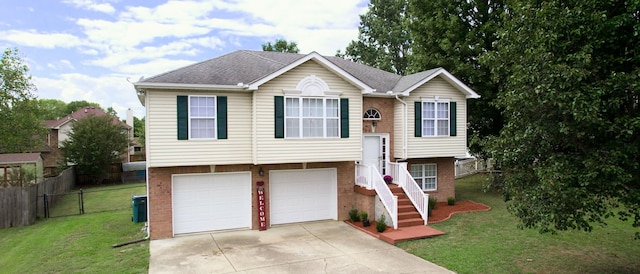 raised ranch with a garage and a front yard