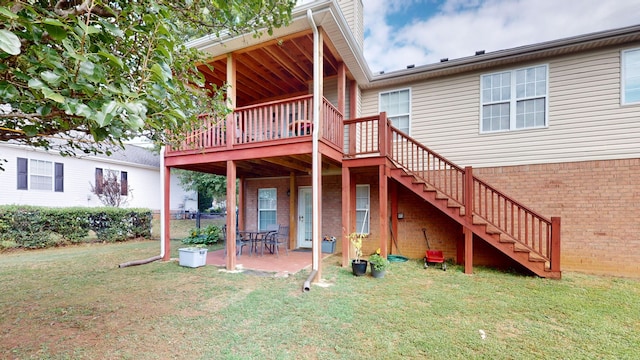 back of house featuring a wooden deck, a yard, and a patio