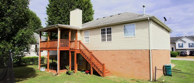 rear view of house featuring a lawn