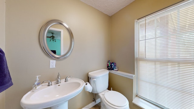 bathroom featuring a textured ceiling, sink, and toilet