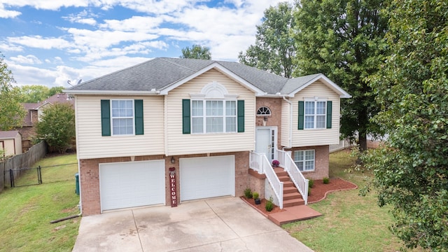 split foyer home with a garage and a front lawn