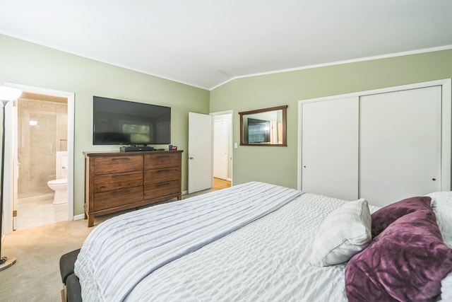 bedroom with connected bathroom, a closet, crown molding, lofted ceiling, and light carpet