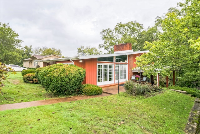 rear view of house featuring a yard