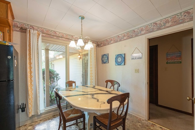 dining space with a notable chandelier