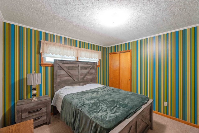 carpeted bedroom with a textured ceiling and a closet