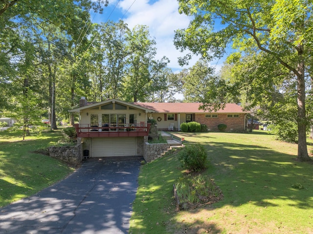 single story home featuring a garage and a front lawn