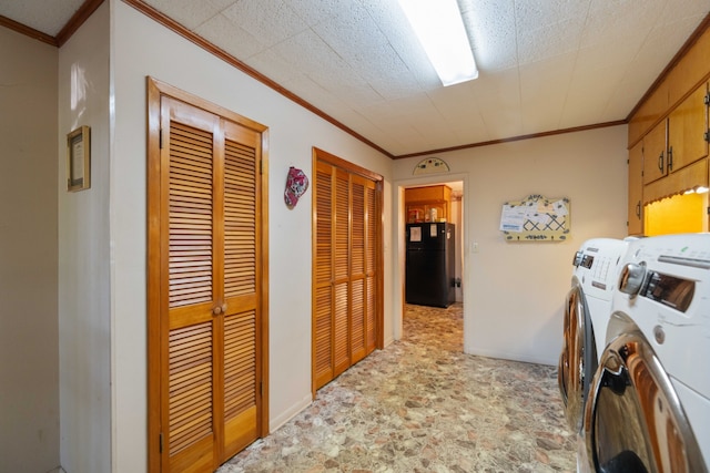 laundry room with washing machine and dryer, ornamental molding, and cabinets