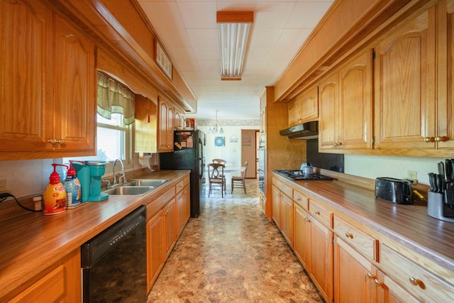 kitchen featuring hanging light fixtures, black appliances, sink, and wood counters