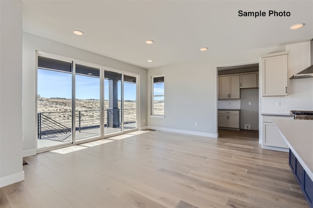 0 Keystone Dr, Pleasant View, TN 37146 - interior space featuring wall chimney exhaust hood, light hardwood / wood-style floors, stainless steel range oven, and a healthy amount of sunlight