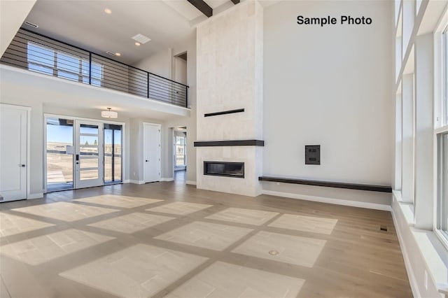 0 Keystone Dr, Pleasant View, TN 37146 - unfurnished living room featuring a towering ceiling, a tiled fireplace, and light wood-style flooring
