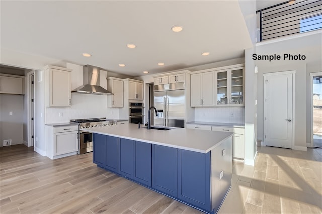 0 Keystone Dr, Pleasant View, TN 37146 - kitchen with light wood-type flooring, sink, an island with sink, wall chimney exhaust hood, and premium appliances