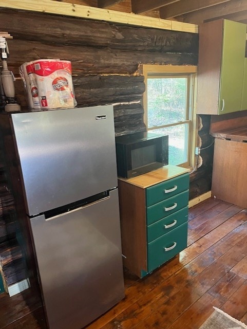 kitchen featuring stainless steel refrigerator, dark hardwood / wood-style floors, and green cabinets