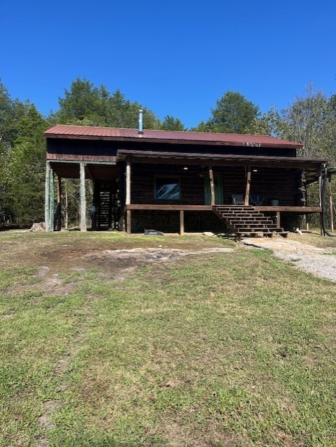 back of house with a lawn