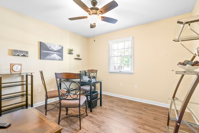 dining space featuring wood-type flooring and ceiling fan