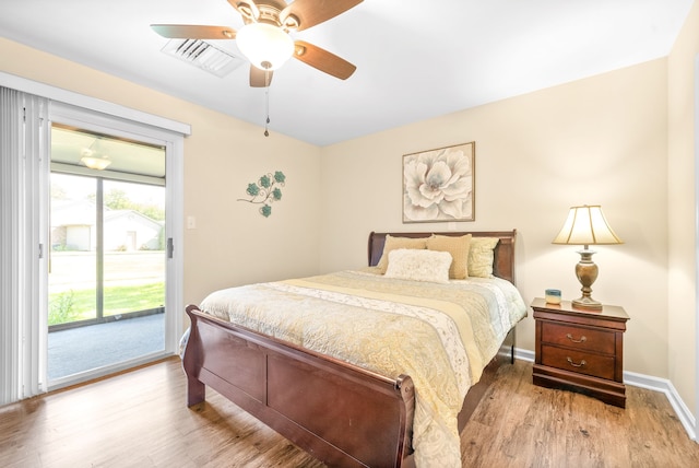 bedroom with hardwood / wood-style floors, ceiling fan, and access to outside