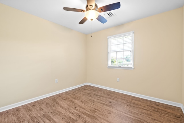 spare room featuring wood-type flooring and ceiling fan