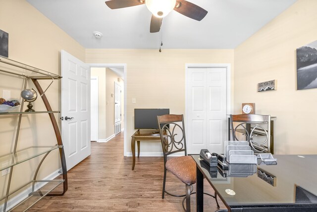 home office with ceiling fan and hardwood / wood-style flooring